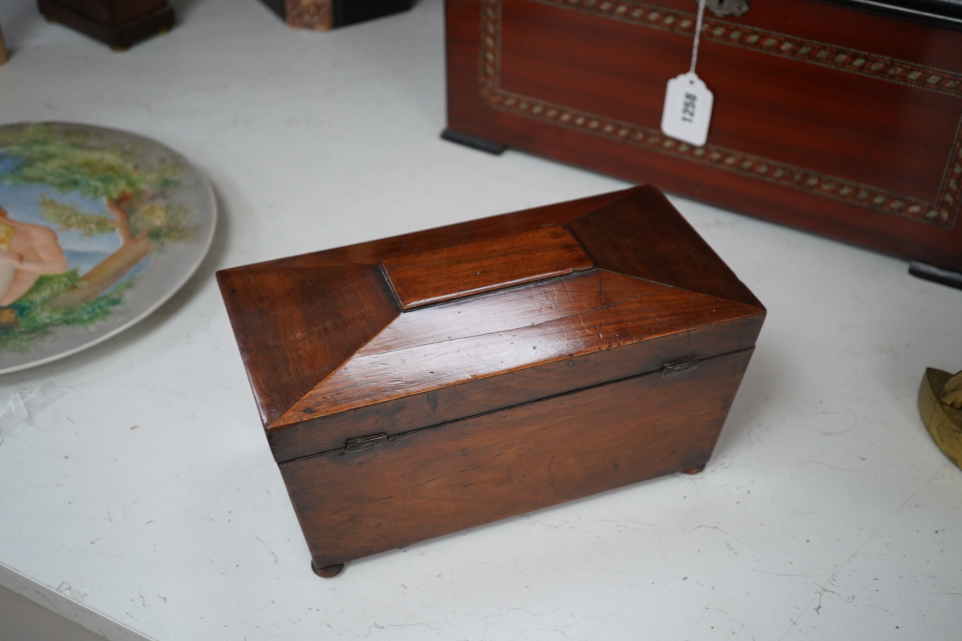 A Victorian mahogany sarcophagus shaped tea caddy with mother of pearl inlaid escutcheon, 28cm. Condition - fair